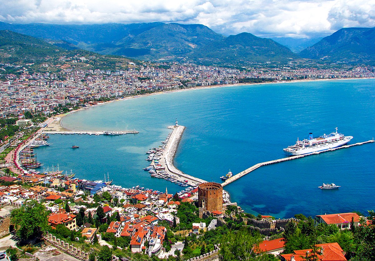 Alanya is a resort town on Turkey’s central Mediterranean coast (also known as the Turkish Riviera). Its wide beaches lined with hotels include Cleopatra Beach, where the Egyptian queen reputedly swam. Alanya Castle, a giant Seljuk-era fort turned open-air museum, stands on a rocky bluff above the beachfront, alongside red-tile-roofed Ottoman villas and the octagonal Red Tower, a symbol of the city dating to 1226.